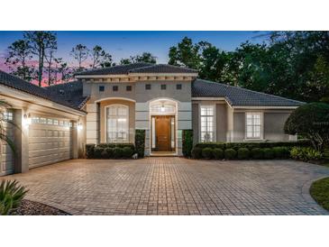 Stunning single-story home with a brick driveway and meticulously maintained landscaping at 3400 Oakmont Ter, Longwood, FL 32779
