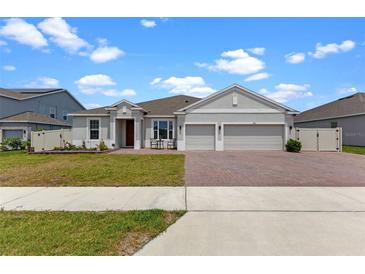 Charming single-story home featuring a two-car garage, brick-paved driveway, and well-manicured lawn at 5981 Sierra Crown St, Mount Dora, FL 32757