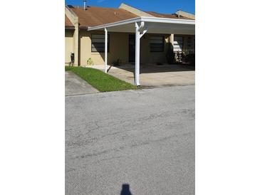 Charming townhouse with a covered carport and well-maintained front yard at 2218 Abbey Rd, Winter Haven, FL 33880