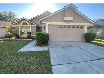 Charming single-story home with a well-maintained lawn and attached two car garage at 3124 Ginger Cir, Orlando, FL 32826