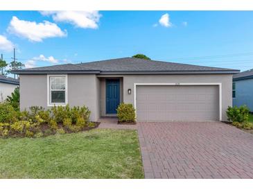 Charming single-story home featuring a brick driveway, attached garage, and well-manicured lawn at 439 Sarah Nicole Way, New Smyrna Beach, FL 32168