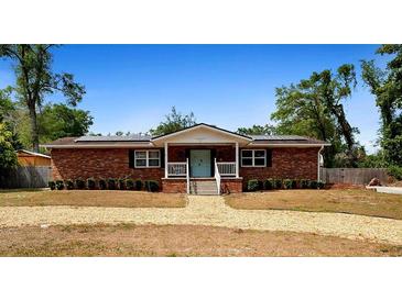 Charming single-story brick home with a welcoming front porch and a well-maintained gravel yard at 617 E Citrus St, Altamonte Springs, FL 32701