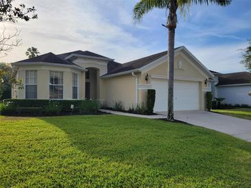 Lovely one-story home features a well-manicured lawn and a two-car garage at 643 Orista Dr, Davenport, FL 33897