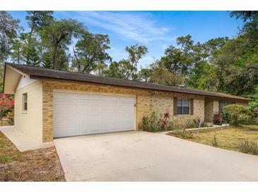 Charming single-story home with a two-car garage, brick exterior, and well-maintained landscaping at 180 Broadmoor Rd, Lake Mary, FL 32746