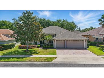 Charming single-story home boasts a manicured lawn, mature trees, and a three-car garage, creating a welcoming curb appeal at 2391 Northumbria Dr, Sanford, FL 32771