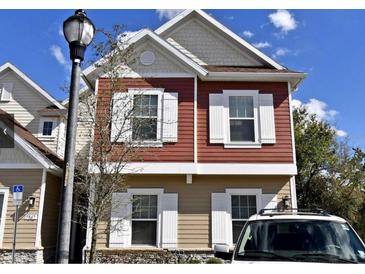 Charming two-story home featuring white shutters, a gable roof, and a well-maintained exterior at 7514 Sunville Ave, Kissimmee, FL 34747