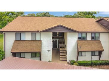 Inviting exterior view of a two-story condo building with brown roofing and well-maintained landscaping at 516 Bahia Cir # B, Ocala, FL 34472
