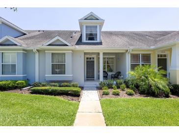 Charming single-story townhome featuring a well-manicured lawn and inviting front porch area at 14262 Tanja King Blvd, Orlando, FL 32828