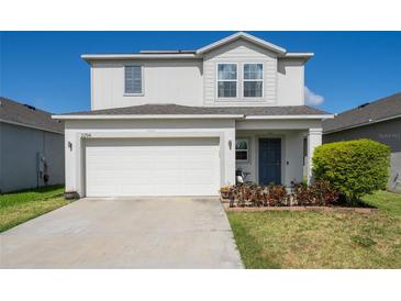 Charming two-story home featuring a two-car garage and a beautifully landscaped front yard at 2294 Canyon Breeze Ave Ave, Kissimmee, FL 34746