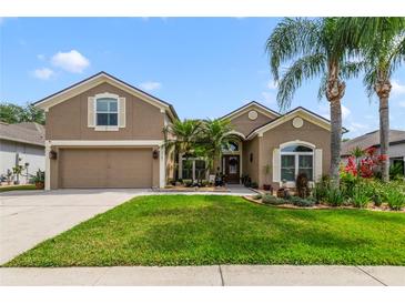 Charming home with well-maintained lawn, mature landscaping, and a two-car garage in a peaceful neighborhood at 2787 Cypress Head Trl, Oviedo, FL 32765