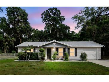Charming single story home featuring a manicured lawn and lovely front porch seating area at 368 E Chelsea St, Deland, FL 32724