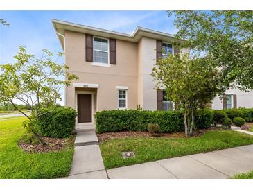 Charming two-story home with a well-manicured lawn and neatly trimmed hedges at 4801 Apple Blossom Ln, St Cloud, FL 34771
