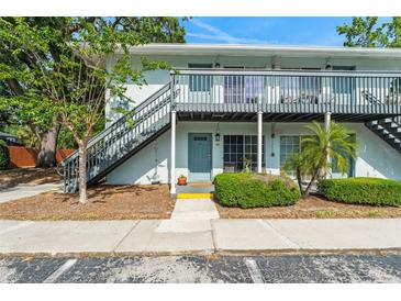 Inviting condo building featuring dual exterior stairs and neatly landscaped grounds, presenting a charming curb appeal at 4820 S Conway Rd # 131, Orlando, FL 32812