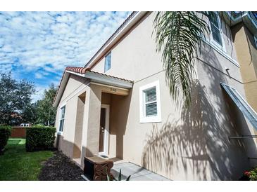 Inviting exterior of home featuring neutral stucco, red-tiled roof, and well-maintained landscaping at 550 Las Fuentes Dr, Kissimmee, FL 34746