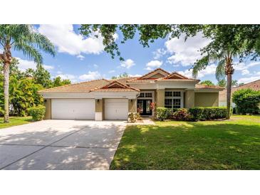 Charming single-story home with a three-car garage and well-manicured lawn at 6550 Crestmont Glen Ln, Windermere, FL 34786