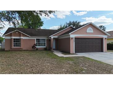 Charming single-story home featuring a well-maintained lawn and a two-car garage at 7700 Greytwig Ln, Orlando, FL 32818