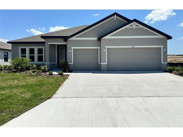 Charming single-story home with a well-maintained lawn and a spacious two-car garage at 4015 Maggie Loop, Lakeland, FL 33813