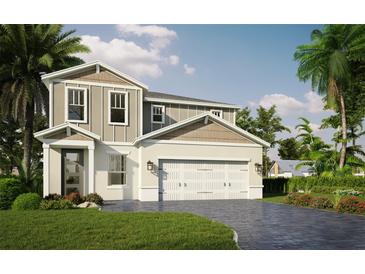 Inviting two-story home with a gray-beige exterior, complemented by lush landscaping and a brick-paved driveway at 106 Elena Lavin Cir # 19, Orlando, FL 32807