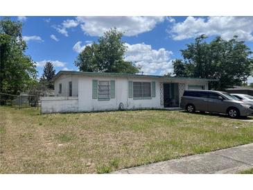 Charming single-story home featuring green shutters and patterned concrete accents with an attached garage and well-lit yard at 1371 W Wellington Dr, Deltona, FL 32725