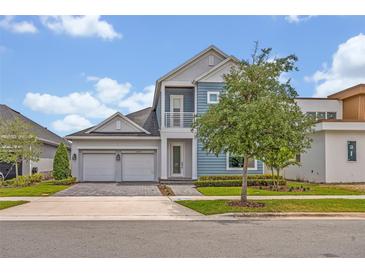 Charming two-story home featuring a two-car garage, balcony, and beautifully landscaped front yard at 14559 Walcott Ave, Orlando, FL 32827