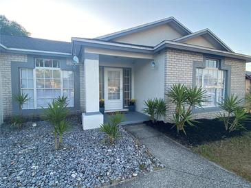 Charming single-story home with decorative rock landscaping, garden bed, and welcoming front entryway at 2236 Dancy Trail Trl, Clermont, FL 34714