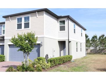 Charming two-story home with attached garage, landscaped yard, neutral-toned siding, and well-maintained lawn at 2415 Sweet Viburnum Way, Ocoee, FL 34761