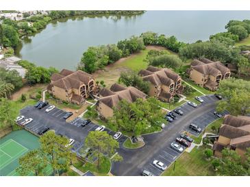 Condo complex featuring multiple buildings, ample parking, and mature landscaping offering serene living at 390 Lake Placid Ct # 304, Altamonte Springs, FL 32701