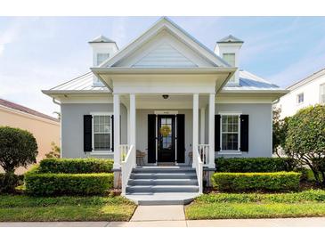 Charming home featuring a cozy porch, dormer windows, and neatly manicured landscaping, offering great curb appeal at 4148 Oak St, Orlando, FL 32814