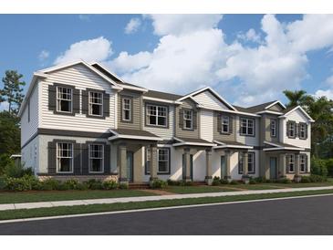 Charming townhome exteriors featuring neutral paint, decorative shutters, and covered front entries, all surrounded by lush landscaping at 652 Pothos St, Apopka, FL 32703