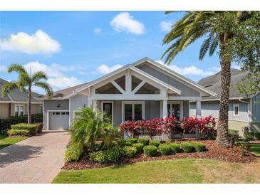 Charming single-story home featuring a well-manicured lawn, beautiful landscaping, and a welcoming front porch at 9405 Bordet Ct, Orlando, FL 32827