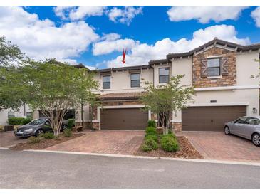 Charming townhome with brick-paved driveway and attached two-car garage at 1227 Sandwedge St, Davenport, FL 33896