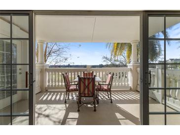 Inviting patio with table set and views of the surrounding green landscape at 1370 Centre Court Ridge Dr # 204, Reunion, FL 34747
