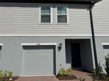 Charming two-story townhome features a one-car garage and a welcoming entrance at 16468 Happy Eagle Dr, Clermont, FL 34714