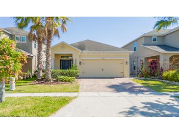 Charming one-story home with a two-car garage, brick driveway, and well-maintained landscaping at 2790 Monticello Way, Kissimmee, FL 34741