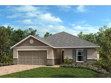 Charming single-story home with a two-car garage, manicured lawn, and tasteful landscaping at 3281 Sanctuary Dr, Clermont, FL 34714