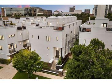 Modern multi-level townhouse showcasing sleek lines and rooftop terraces in a vibrant urban setting at 356 S Osceola Ave # 19, Orlando, FL 32801