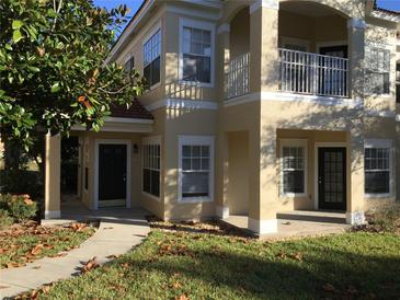 Inviting two-story townhouse with a balcony, walkway, and well-maintained lawn at 711 Arbor Lakes Cir # 711, Sanford, FL 32771