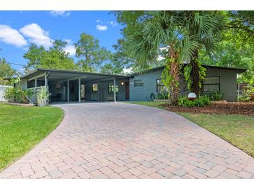 Charming home featuring a brick driveway, lovely yard, and inviting facade with a carport at 808 Denton Rd, Winter Park, FL 32792