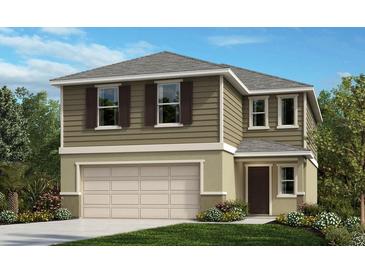 Charming two-story home with a two-car garage and beautifully landscaped front yard at 8328 Caribbean Pine Way, Lakeland, FL 33809