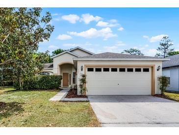 Charming single-story home with a two-car garage and a well-maintained lawn at 11460 Brown Quail Ct, Orlando, FL 32817