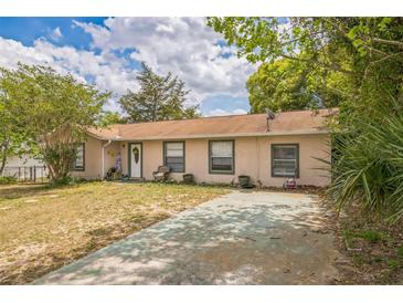 Charming one-story home with a quaint front yard, painted drive, and mature landscaping at 3 Spring Lane Way, Ocala, FL 34472