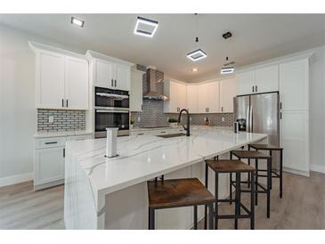 Modern kitchen features a large island, stainless steel appliances, and stylish lighting fixtures at 59 W 10Th St, Apopka, FL 32703