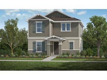 Charming two-story home with a mix of vertical siding and cedar shake accents and well-manicured landscaping at 9120 Norley Ct, Davenport, FL 33896