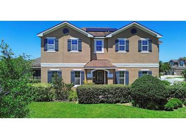 Charming two-story home with manicured landscaping and classic architectural details at 3008 Cardillino Way, Kissimmee, FL 34741