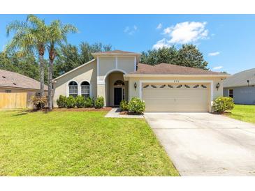 Charming single-Gathering home featuring a well-maintained lawn, a two car garage, and lush landscaping at 830 Grand Hughey Ct, Apopka, FL 32712