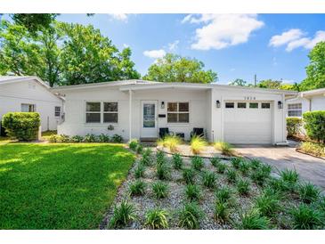 Charming single-story home with manicured lawn and white painted brick at 1424 W New Hampshire St, Orlando, FL 32804