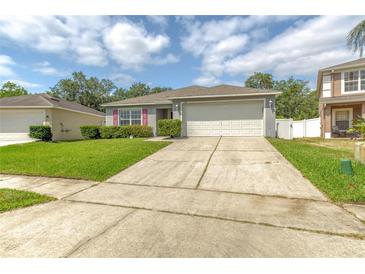 Well-maintained home with a two-car garage, green lawn, and trimmed hedges at 177 Bristol Forest Trl, Sanford, FL 32771