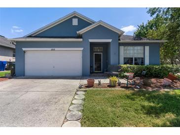 Charming single-story home featuring an attached garage and lush landscaping at 1868 Rachels Ridge Loop # L, Ocoee, FL 34761