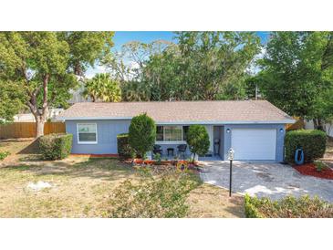 Charming single-story home with a well-manicured lawn and a brick driveway at 1901 Rose Blvd, Orlando, FL 32839