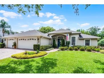 Charming single-story home with a well-manicured lawn, paver driveway and mature landscaping at 224 Bluestone Pl, Casselberry, FL 32707